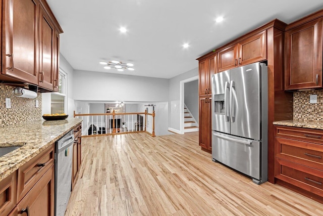 966 Larkstone Dr, Columbus, OH 43235 - kitchen featuring appliances with stainless steel finishes, light wood-style flooring, decorative backsplash, light stone counters, and recessed lighting