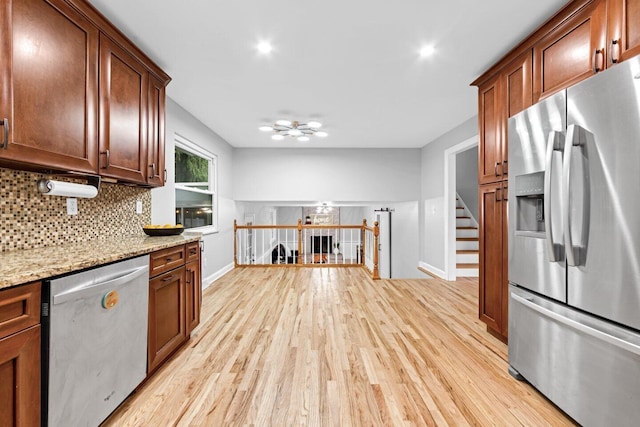 966 Larkstone Dr, Columbus, OH 43235 - kitchen featuring appliances with stainless steel finishes, light wood-style flooring, decorative backsplash, light stone countertops, and recessed lighting