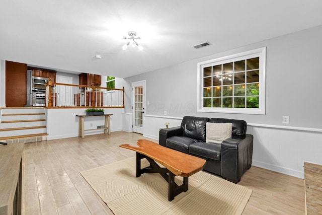 966 Larkstone Dr, Columbus, OH 43235 - living area with light wood-style floors, stairway, and healthy amount of natural light