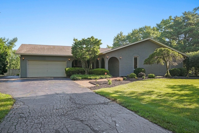 2500 Carriage Rd, Powell, OH 43065 - ranch-style home featuring a garage, a front yard, brick siding, and asphalt driveway