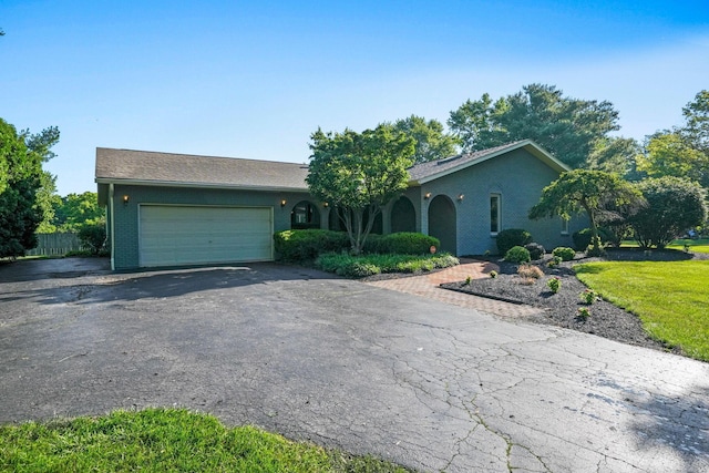 2500 Carriage Rd, Powell, OH 43065 - ranch-style house with asphalt driveway, an attached garage, and brick siding