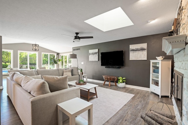 2500 Carriage Rd, Powell, OH 43065 - living room with wood finished floors, a textured ceiling, ceiling fan, lofted ceiling, and a skylight