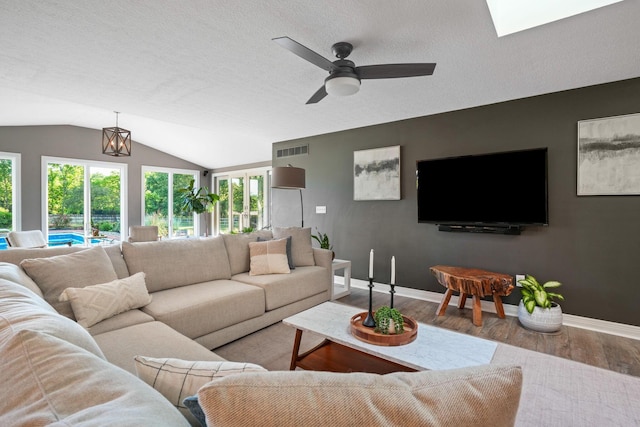 2500 Carriage Rd, Powell, OH 43065 - living room featuring wood finished floors, ceiling fan, lofted ceiling, and a textured ceiling