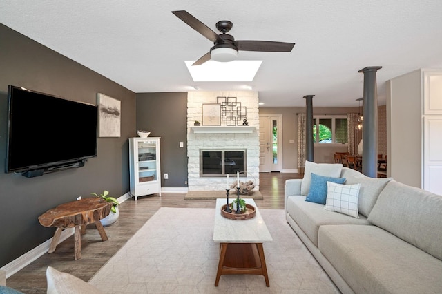 2500 Carriage Rd, Powell, OH 43065 - living area with a skylight, a ceiling fan, wood finished floors, and a fireplace