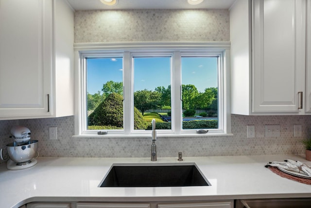 2500 Carriage Rd, Powell, OH 43065 - kitchen with white cabinetry, backsplash, light countertops, and dishwasher