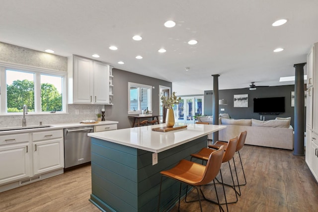 2500 Carriage Rd, Powell, OH 43065 - kitchen featuring stainless steel dishwasher, a kitchen island, open floor plan, white cabinetry, and recessed lighting