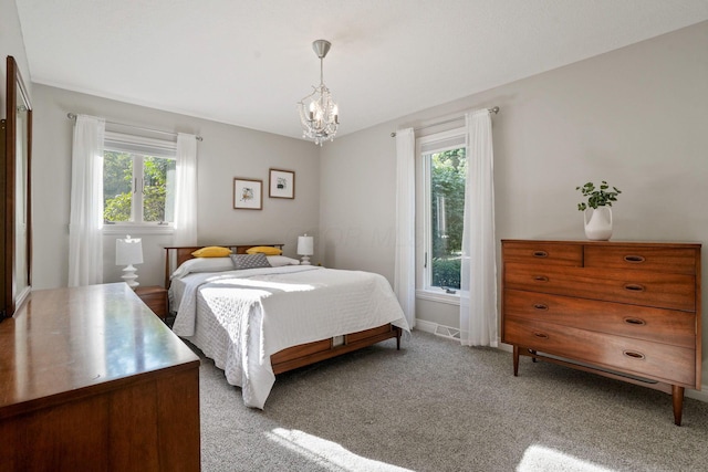 2500 Carriage Rd, Powell, OH 43065 - bedroom with multiple windows, a chandelier, and light carpet