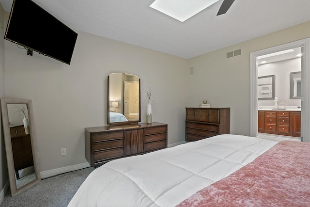 2500 Carriage Rd, Powell, OH 43065 - bedroom with light colored carpet, ensuite bath, a skylight, and ceiling fan