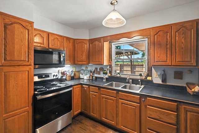 1994 County Road 61, Edison, OH 43320 - kitchen with black microwave, electric range, dark countertops, brown cabinetry, and decorative light fixtures