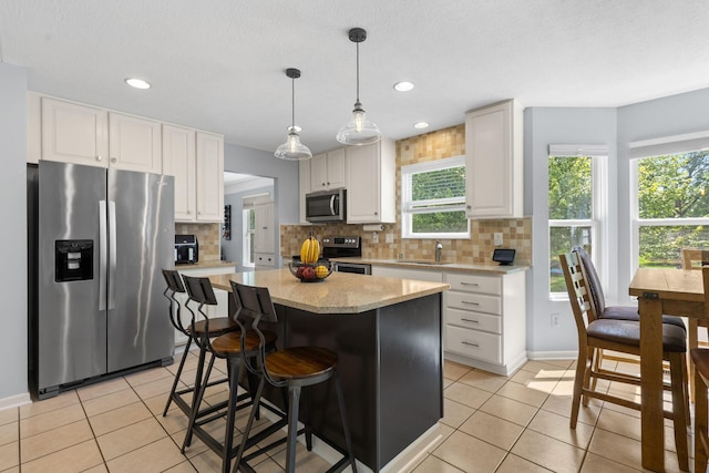 1271 Fareharm Dr, New Albany, OH 43054 - kitchen featuring stainless steel appliances, light tile patterned floors, backsplash, white cabinetry, and recessed lighting