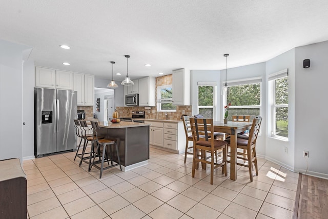 1271 Fareharm Dr, New Albany, OH 43054 - kitchen with stainless steel appliances, tasteful backsplash, plenty of natural light, white cabinets, and recessed lighting