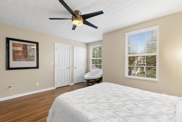 1271 Fareharm Dr, New Albany, OH 43054 - bedroom with wood finished floors, a textured ceiling, multiple closets, and a ceiling fan