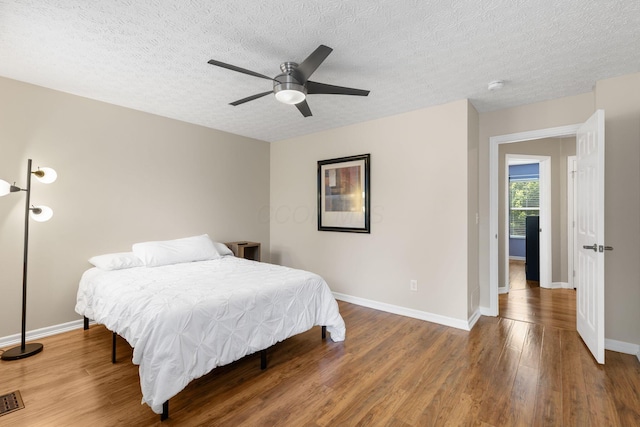 1271 Fareharm Dr, New Albany, OH 43054 - bedroom featuring wood finished floors, a textured ceiling, and ceiling fan