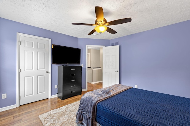 1271 Fareharm Dr, New Albany, OH 43054 - bedroom with light wood-type flooring, a textured ceiling, and a ceiling fan