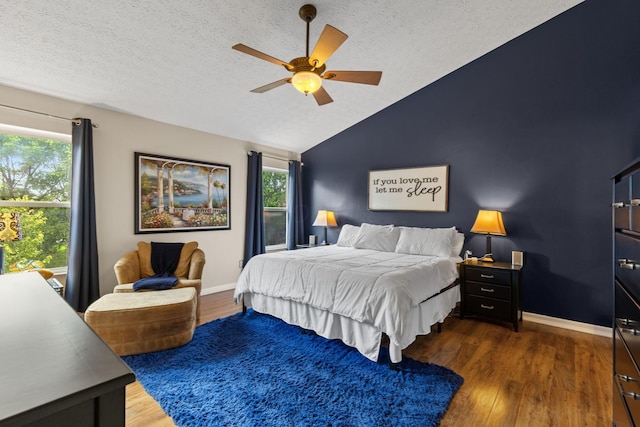 1271 Fareharm Dr, New Albany, OH 43054 - bedroom with multiple windows, vaulted ceiling, wood finished floors, a textured ceiling, and ceiling fan
