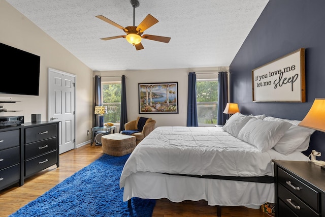 1271 Fareharm Dr, New Albany, OH 43054 - bedroom with lofted ceiling, a textured ceiling, light wood-style floors, and a ceiling fan