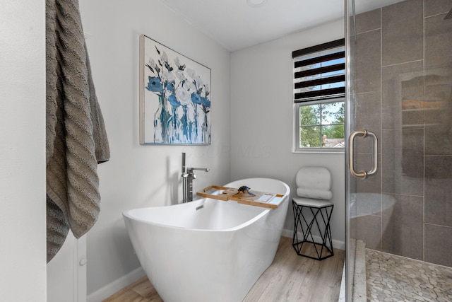 1271 Fareharm Dr, New Albany, OH 43054 - full bath featuring wood finished floors, a stall shower, and a soaking tub