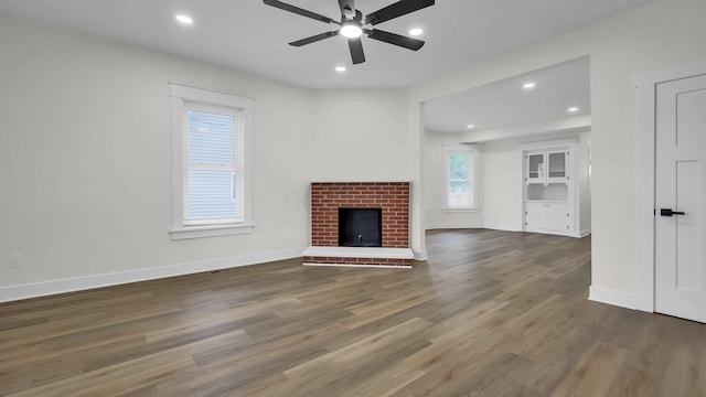 732 Columbus Ave, Washington Court House, OH 43160 - unfurnished living room with ceiling fan, wood finished floors, recessed lighting, and a brick fireplace