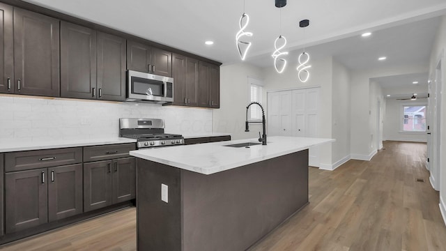 732 Columbus Ave, Washington Court House, OH 43160 - kitchen featuring appliances with stainless steel finishes, decorative backsplash, wood finished floors, dark brown cabinetry, and recessed lighting