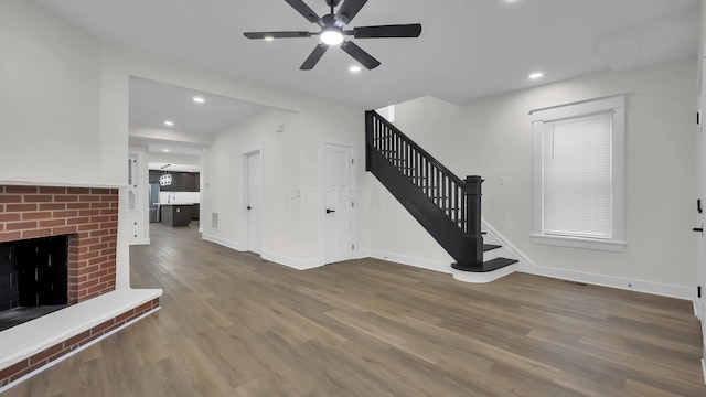 732 Columbus Ave, Washington Court House, OH 43160 - unfurnished living room featuring stairway, a ceiling fan, wood finished floors, a fireplace, and recessed lighting