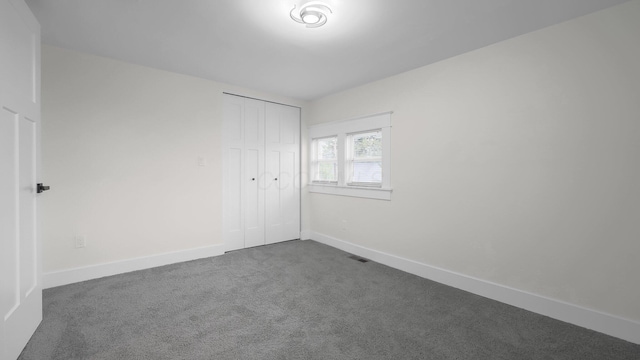 732 Columbus Ave, Washington Court House, OH 43160 - unfurnished bedroom featuring dark carpet and a closet
