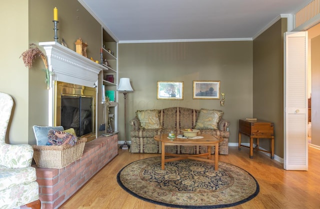 409 N High St, Lancaster, OH 43130 - living area featuring wood finished floors, crown molding, and a brick fireplace