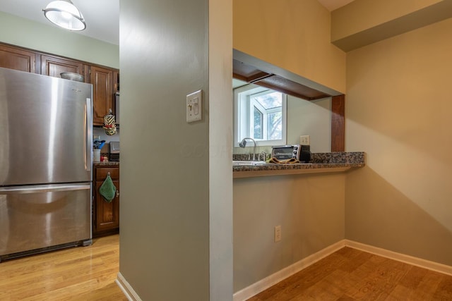 409 N High St, Lancaster, OH 43130 - kitchen with freestanding refrigerator and light wood-type flooring