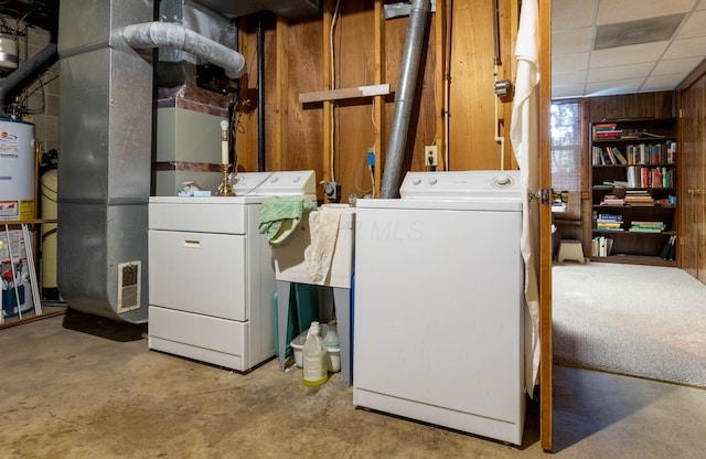 409 N High St, Lancaster, OH 43130 - laundry area featuring washer and dryer, gas water heater, wooden walls, and heating unit