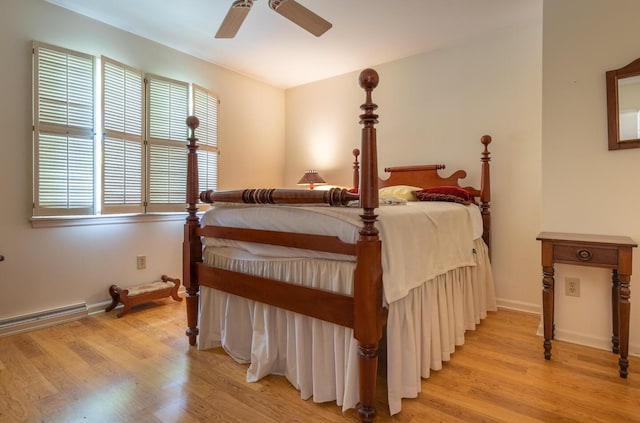 409 N High St, Lancaster, OH 43130 - bedroom featuring baseboard heating, light wood-style floors, and a ceiling fan