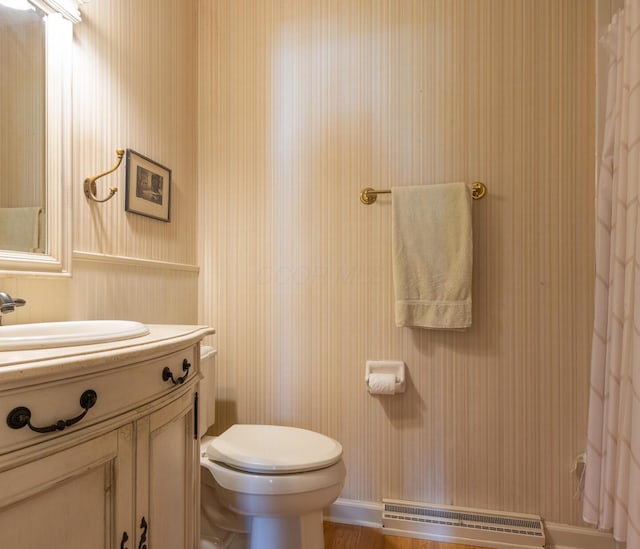 409 N High St, Lancaster, OH 43130 - bathroom with wallpapered walls, vanity, a shower with shower curtain, and baseboard heating