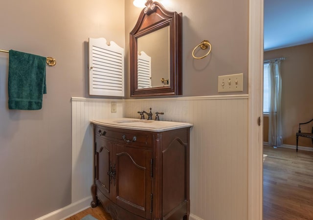 409 N High St, Lancaster, OH 43130 - bathroom featuring wainscoting, wood finished floors, and vanity