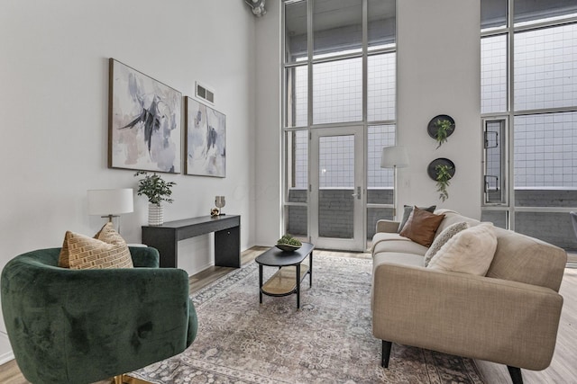 60 E Spring St Unit 220, Columbus, OH 43215 - living area with wood finished floors, a high ceiling, and plenty of natural light
