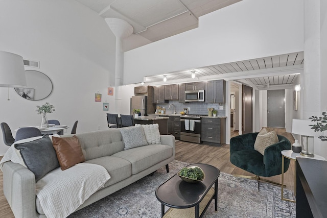60 E Spring St Unit 220, Columbus, OH 43215 - living area featuring wood finished floors and a high ceiling
