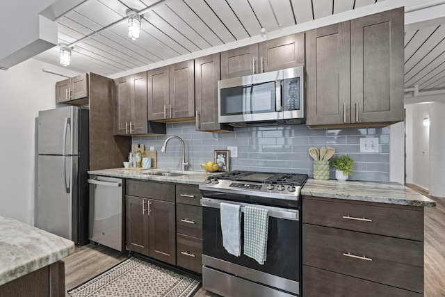 60 E Spring St Unit 220, Columbus, OH 43215 - kitchen with stainless steel appliances, light wood-type flooring, dark brown cabinetry, and wood ceiling