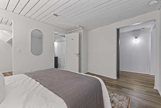 60 E Spring St Unit 220, Columbus, OH 43215 - bedroom with wood finished floors and baseboards