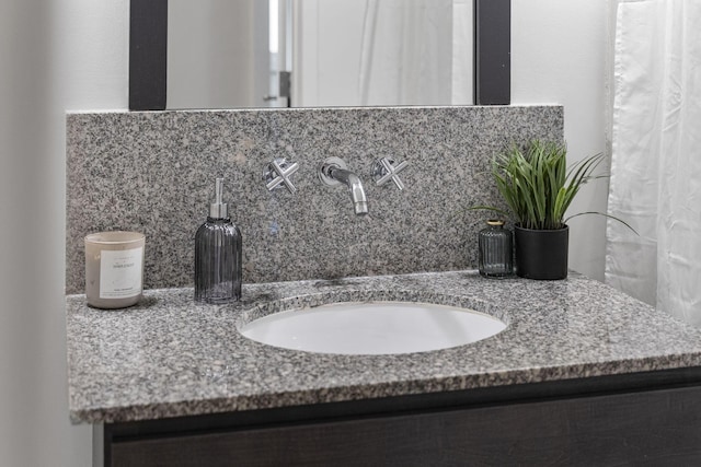 60 E Spring St Unit 220, Columbus, OH 43215 - bathroom featuring vanity and tasteful backsplash