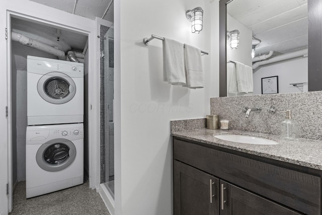 60 E Spring St Unit 220, Columbus, OH 43215 - full bath featuring stacked washer / drying machine, a stall shower, and vanity