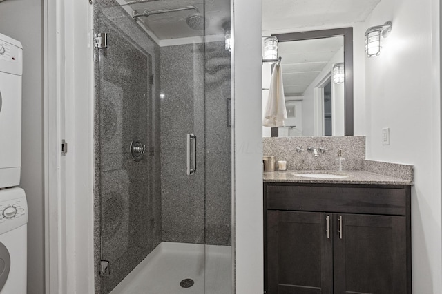 60 E Spring St Unit 220, Columbus, OH 43215 - full bath with stacked washer and clothes dryer, a stall shower, and vanity