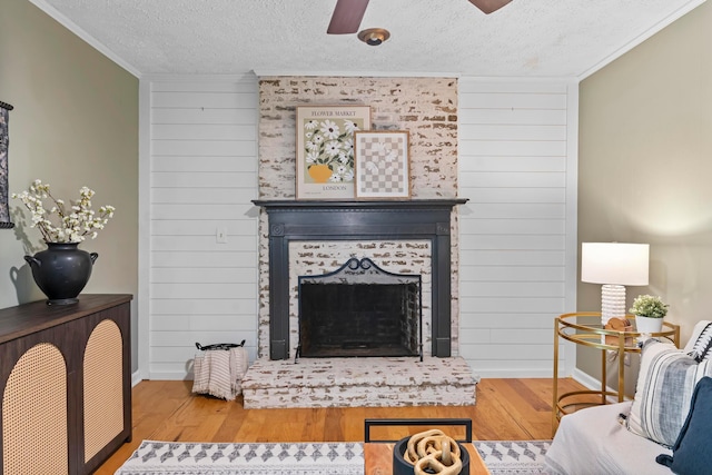 6666 Sharon Woods Blvd, Columbus, OH 43229 - living room featuring ceiling fan, ornamental molding, a textured ceiling, wood finished floors, and wood walls