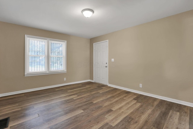 1077-1079 S James Rd, Columbus, OH 43227 - spare room featuring baseboards and dark wood-type flooring