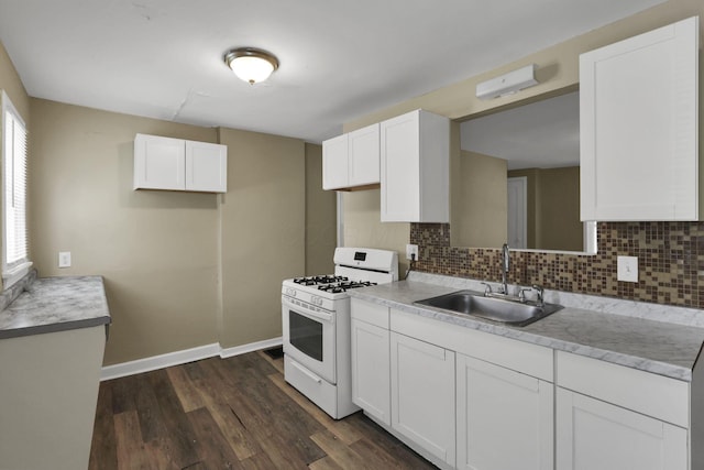 1077-1079 S James Rd, Columbus, OH 43227 - kitchen featuring white gas stove, decorative backsplash, dark wood-style floors, light countertops, and white cabinetry