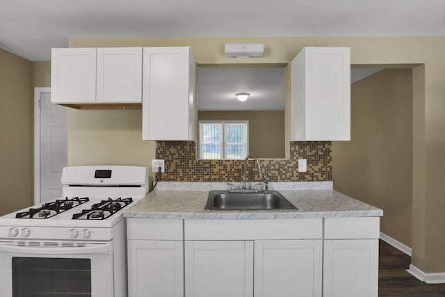 1077-1079 S James Rd, Columbus, OH 43227 - kitchen with white gas stove, white cabinets, light countertops, and tasteful backsplash