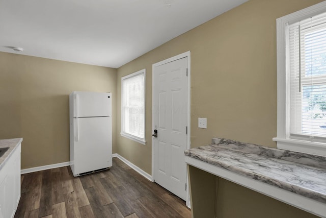 1077-1079 S James Rd, Columbus, OH 43227 - kitchen featuring freestanding refrigerator, dark wood-style flooring, white cabinetry, and light stone countertops