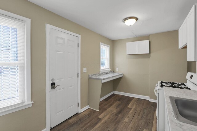 1077-1079 S James Rd, Columbus, OH 43227 - kitchen with white gas range, dark wood-style floors, white cabinetry, and light countertops