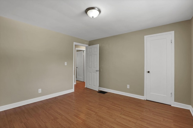 1077-1079 S James Rd, Columbus, OH 43227 - unfurnished bedroom featuring light wood finished floors and baseboards