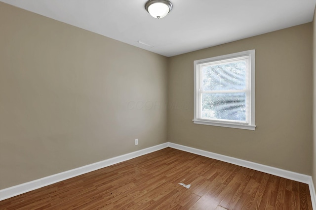 1077-1079 S James Rd, Columbus, OH 43227 - spare room featuring baseboards and wood finished floors