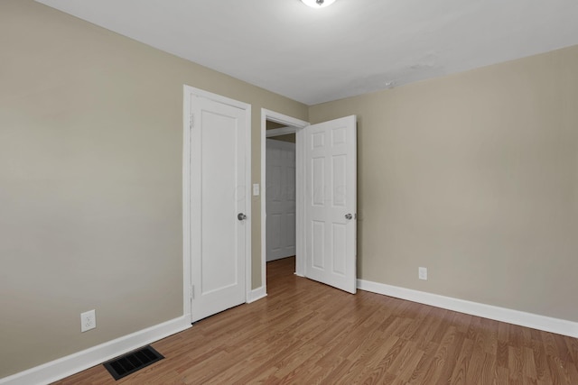 1077-1079 S James Rd, Columbus, OH 43227 - unfurnished bedroom featuring baseboards and wood finished floors