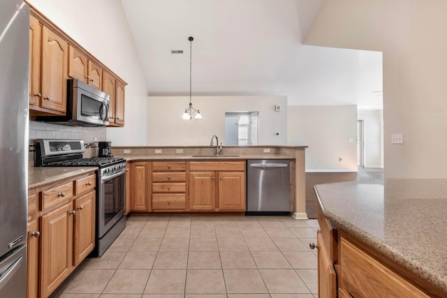 810 Lambton Cir W, Lancaster, OH 43130 - kitchen with stainless steel appliances, a peninsula, vaulted ceiling, backsplash, and light tile patterned flooring