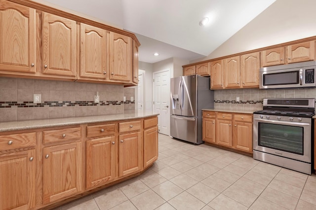 810 Lambton Cir W, Lancaster, OH 43130 - kitchen with stainless steel appliances, light countertops, light tile patterned flooring, vaulted ceiling, and backsplash