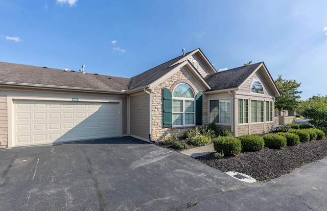 810 Lambton Cir W, Lancaster, OH 43130 - ranch-style home featuring stone siding, asphalt driveway, an attached garage, and a shingled roof